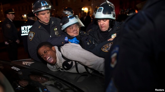 New York Police Department (NYPD) officers arrest a young man during a protest against the killing of 16-year-old Kimani "Kiki" Gray who was killed in a shooting involving the NYPD, in the Brooklyn borough of New York Mar. 13, 2013.