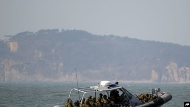 South Korean navy sailors in a speed boat patrol around South Korea's western Yeonpyong Island after finishing their exercise, near the disputed sea border with North Korea, February 20, 2012.
