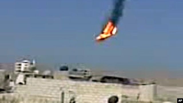 This citizen journalism image purports to show a Syrian military helicopter on fire and falling to the ground after it was apparently hit during fighting between government forces and rebels in Damascus, Aug 27, 2012. AP IS UNABLE TO INDEPENDENTLY VERIFY 