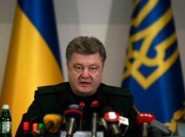 Ukrainian President Petro Poroshenko issues the order to start a cease-fire in the east during a meeting with defense officials in Kyiv, Feb. 15, 2015.