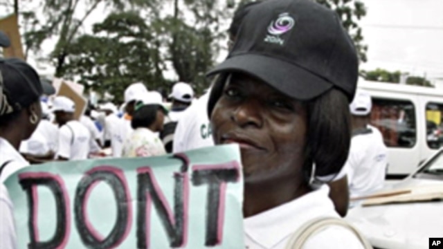 A lady carries placard at St. Leo Catholic church in Lagos, 09 Sept. 2010