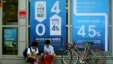 South Korean students sit in front of posters advertising a bank