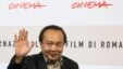 Cambodian director Rithy Panh waves as he poses during a photo call, Oct. 24, 2008 (File)