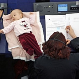 Denmark's member of the European Parliament Hanne Dahl (R) takes part with her baby in a voting session at the European Parliament in Strasbourg March 26, 2009