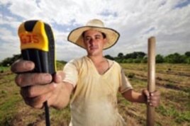 A hand-held satellite device helps a seed collector in Columbia pinpoint wild relatives of stable plants.