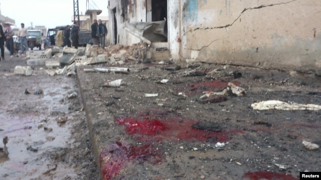 A view shows blood and bread on the ground after what activists said were missiles fired by a Syrian Air Force fighter jet from forces loyal to Syria's President Bashar al-Assad hit a bakery in Halfaya, near Hama December 23, 2012.