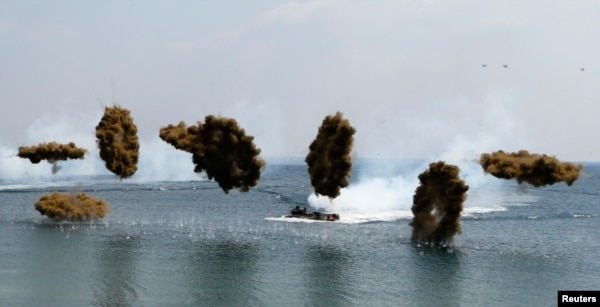 Amphibious assault vehicles of the South Korean Marine Corps throw smoke bombs during a U.S.-South Korea joint landing operation drill in Pohang, southeast of Seoul, during Foal Eagle exercises in 2013.