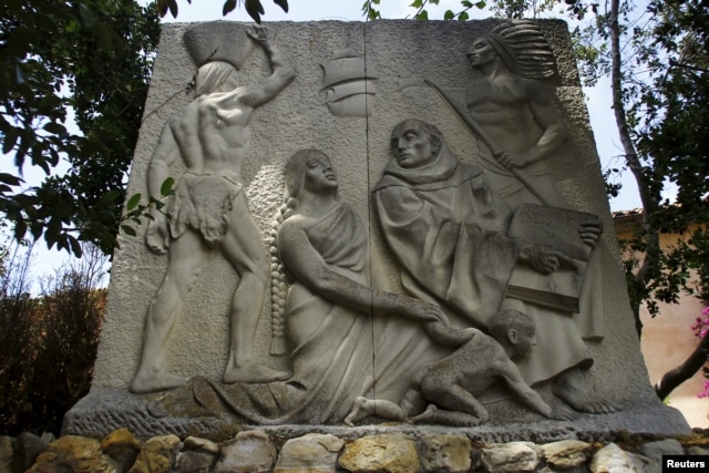 A relief sculpture depicts Father Junipero Serra with Native Americans at the Carmel Mission in Carmel, California, May 5, 2015.