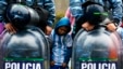 An Argentine fan stands between policemen as they gather to welcome their team outside the Argentine Football Association (AFA)&nbsp;in Buenos Aires after Argentina lost to Germany in their 2014 World Cup final soccer match.