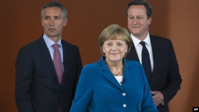 German Chancellor Angela Merkel, center, British PM David Cameron, right, and Norway's PM Jens Stoltenberg, left, arrive for a panel discussion in Berlin, Germany, June 7, 2012.