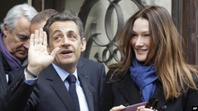 French President and UMP candidate Nicolas Sarkozy and his wife Carla Bruni-Sarkozy leave after casting their votes in the first round of French presidential elections in Paris, France, Sunday, April 22, 2012.