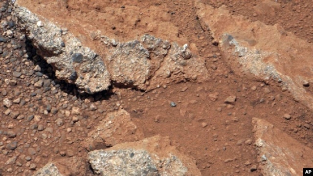 This image provided by NASA shows shows a Martian rock outcrop near the landing site of the rover Curiosity thought to be the site of an ancient streambed. Curiosity landed in a crater near Mars' equator on Aug. 5, 2012, on a two-year mission to study whe