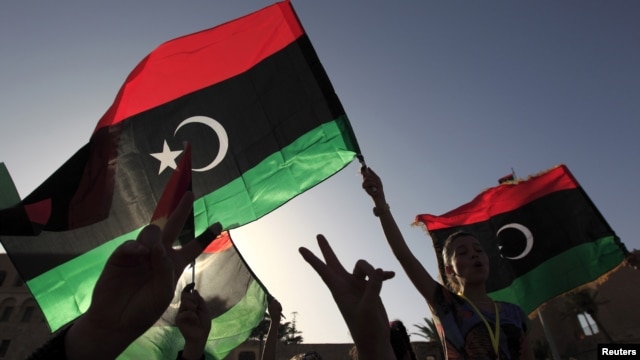 Libyans celebrate on the streets in Tripoli's Martyrs' Square after casting their vote during the National Assembly election, July 7, 2012. 