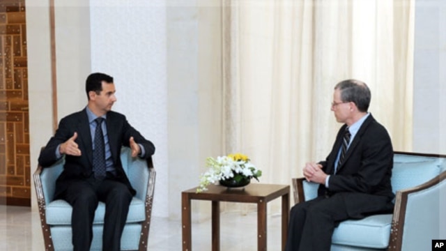 New U.S. ambassador Robert Ford (R) talks with Syria's President Bashar al-Assad after presenting his credentials to Assad, in Damascus January 27, 2011.