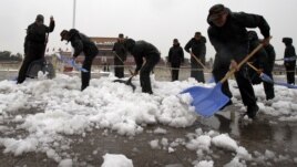 Chinese paramilitary police shovel snow accumulated on Tiananmen Square in Beijing, November 4, 2012.