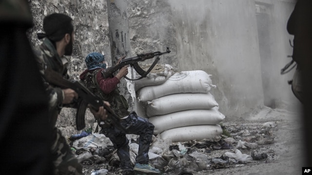 A rebel fighter retreats from government fire during clashes at the Moaskar front line, Aleppo, Syria, Oct. 24, 2012.