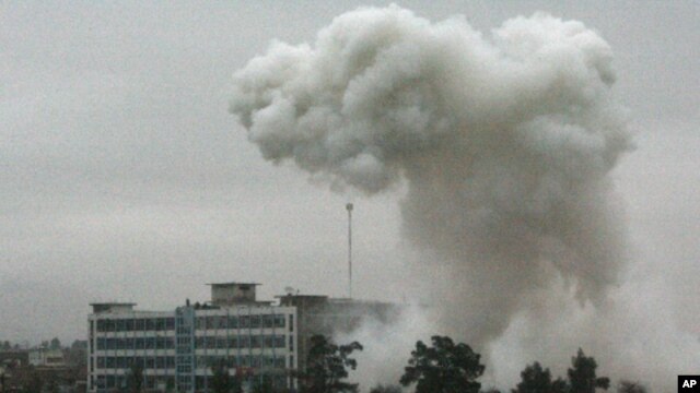 Dust and smoke rise after an explosion in Kandahar, Afghanistan, Feb 12, 2011
