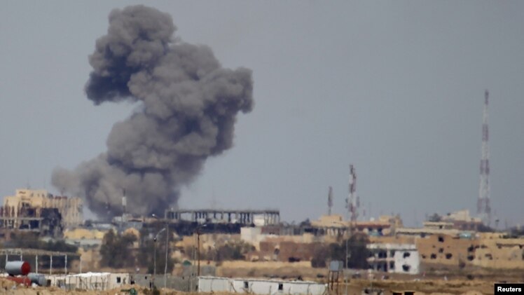 FILE - A plume of smoke rises above a building after an airstrike by the U.S.-led coalition battling the Islamic State group in Tikrit, Iraq, March 27, 2015.