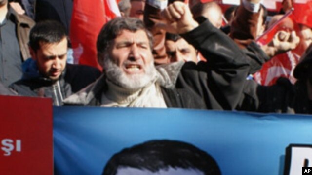 Hundreds of Syrians living in Turkey and human right activists shout anti-Assad slogans as they stage a protest outside the Syrian consulate to condemn the latest killings by Syrian regime in Syria, in Istanbul, Turkey, Sunday, Feb. 5, 2012.
