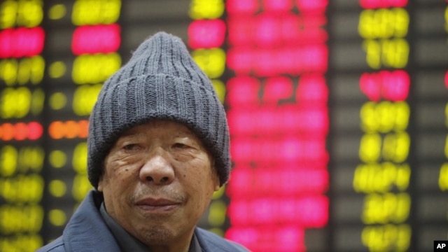 An investor sits in front of the stock price monitor at a private securities company in Shanghai, China, November 22, 2012. 