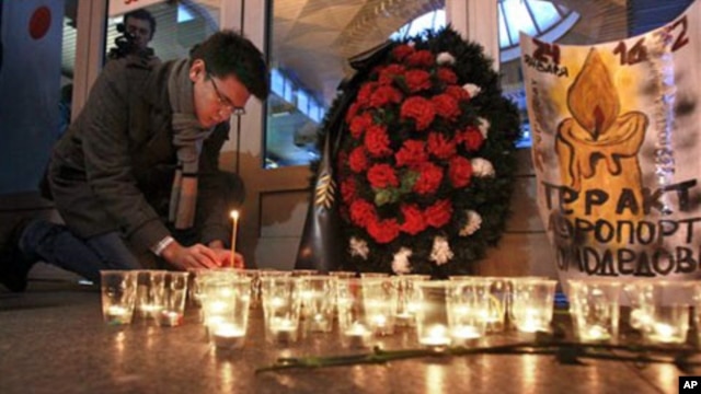 A man lights a candle at the Moskovsky railway station in St.Petersburg, Russia to commemorate the victims of a suicide bombing at Moscow's Domodedovo airport, January 25, 2011