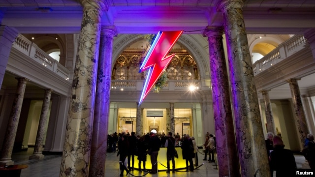 A neon flash representing David Bowie's "Aladdin Sane" stage character is seen at the entrance to the Victoria and Albert Museum to mark the "David Bowie is" exhibition in London, March 20, 2013. 