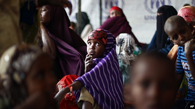 Somali refugees wait outside the UNHCR registration center in the Eastern Kenyan village of Hagadera near Dadaab, 100 kms (60 miles) from the Somali border, August 12, 2011