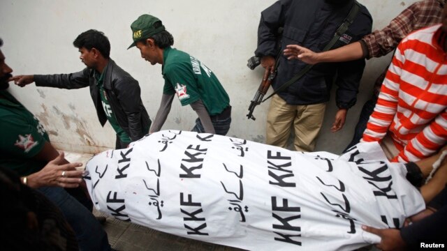 Men move the body of Syed Manzar Imam, a member of the Muttahida Qaumi Movement (MQM) political party and the Sindh provincial assembly who was killed by unidentified gunmen, from the morgue in Karachi's Abbasi Shaheed hospital, January 17, 2013. 