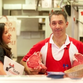 Third-generation Florentine butcher Luca Menoni, with Antoinette Mazzaglia, explains to tourists how he selects the meats for which the city is famous.