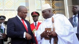 Ghana's President John Dramani Mahama (L) speaks with Gambia's President Yahya Jammeh (R) after a West African regional bloc ECOWAS summit on the crisis in Mali and Guinea Bissau, in Yamoussoukro, Ivory Coast, February 27, 2013.