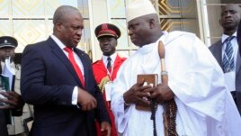 Ghana's President John Dramani Mahama (L) speaks with Gambia's President Yahya Jammeh (R) after a West African regional bloc ECOWAS summit on the crisis in Mali and Guinea Bissau, in Yamoussoukro, Ivory Coast, Feb. 27, 2013.