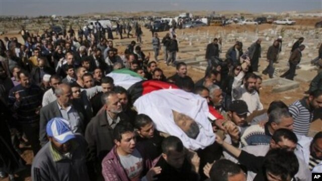 Mourners carry the body of Khairi Saad, 55, who died in the anti-government protests, at the Islamic cemetery in Sahab, near Amman, in Jordan, March 27, 2011