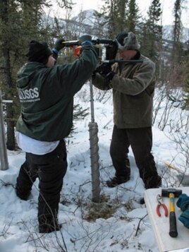 Core samples for microbial analysis are retrieved from the Alaskan permafrost.