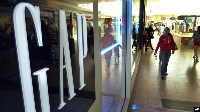 Shoppers walk by the GAP store, file photo. 