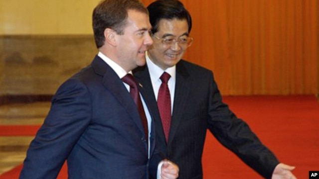 Russian President Dmitry Medvedev, left, with his Chinese counterpart Hu Jintao arrives for a welcoming ceremony at the Great Hall of the People in Beijing, 27 Sept. 2010