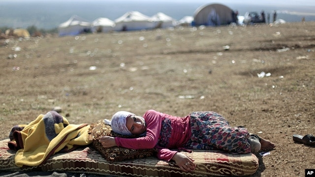 A Syrian girl who fled with her family from the violence in their village, rests at a displaced camp, in the Syrian village of Atmeh, near the Turkish border, Nov. 5, 2012.