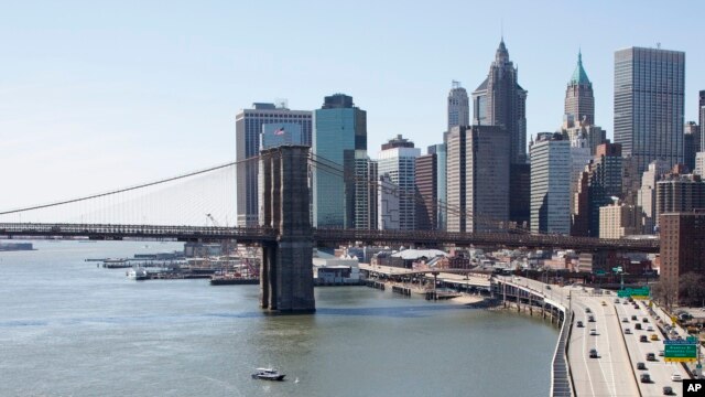 The Brooklyn Bridge and lower Manhattan skyline are shown in a view from the Manhattan Bridge, New York