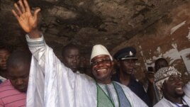 Sierra Leone's incumbent President Ernest Bai Koroma waves to supporters after voting in the capital, Freetown, November 17, 2012.