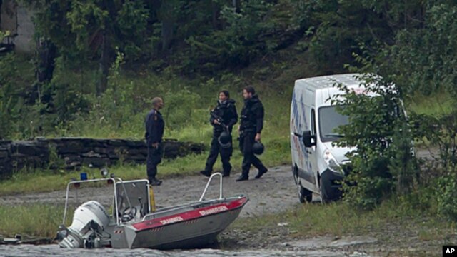 Armed police officers are seen on the island of Utoya, Norway, July 23, 2011