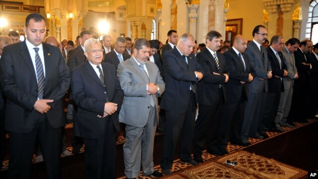 Egyptian President Mohamed Morsi, third left, attends Friday prayers in Cairo, Egypt, April 26, 2013.