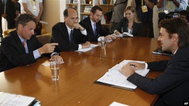 French Finance Minister Francois Baroin (r) listens to U.S Secretary of the Treasury Timothy Geithner (l) during talks in Marseilles,  Sept.9, 2011