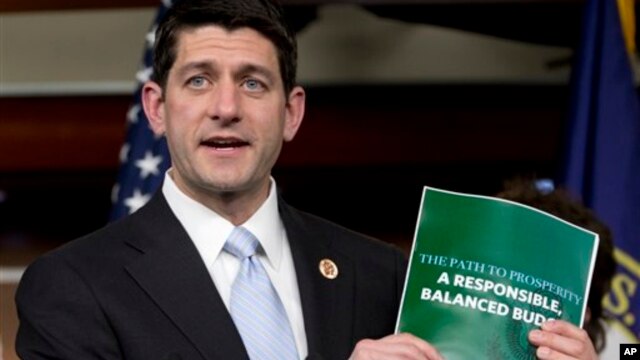Congresman Paul Ryan holds copy of 2014 Budget Resolution March 12, 2013.
