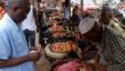 Food prices have shot up in the three countries most affected by Ebola, including Guinea. A customer shops at a market in its capital, Conakry, Aug. 15, 2014.