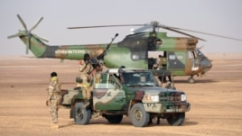 Abasirikare b'igihugu ca Mali bari mw'wikamyo hafi y'indege ya kajugujugu Puma y'igihugu c'Ubufransa