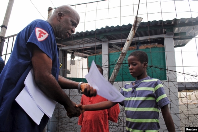 Moses Duo, 9, receives a certificate for being cured of the Ebola virus in Paynesville, Liberia, July 20, 2015.