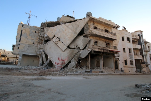 A damaged building is seen in Hraytan city, about 10 kilometers away from the towns of Nubul and Zahraa, Northern Aleppo countryside, Syria, Feb. 3, 2016. The text on the building reads in Arabic: "Agricultural pharmacy."
