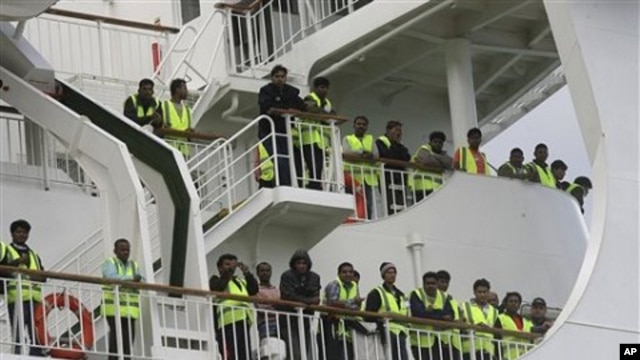 Bangladeshi immigrants evacuated from Libya are seen on the deck of the ferry 'Ionian King' docked inside Souda port in Crete, Greece, March 6, 2011