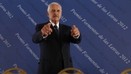 Mexican writer Carlos Fuentes arrives at a news conference announcing the Formentor Prize for Literature 2012 in Mexico City, March 12, 2012. 