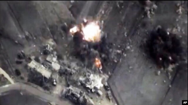 In this photo made from the footage taken from Russian Defense Ministry official web site on Oct. 1, 2015 a bomb explosion is seen in Syria. 