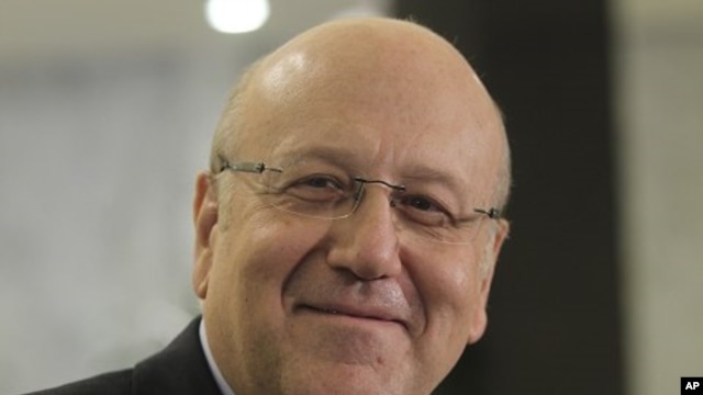 Lebanese MP and former PM Najib Mikati smiles as he delivers a news conference after meeting Lebanon's President Michel Suleiman at the presidential palace in Baabda, near Beirut, during the start of the two-day parliamentary consultations to choose a new